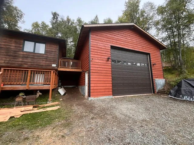 Finished attached garage with matching red siding
